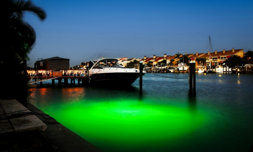 A ship parked at the dock with a green light.