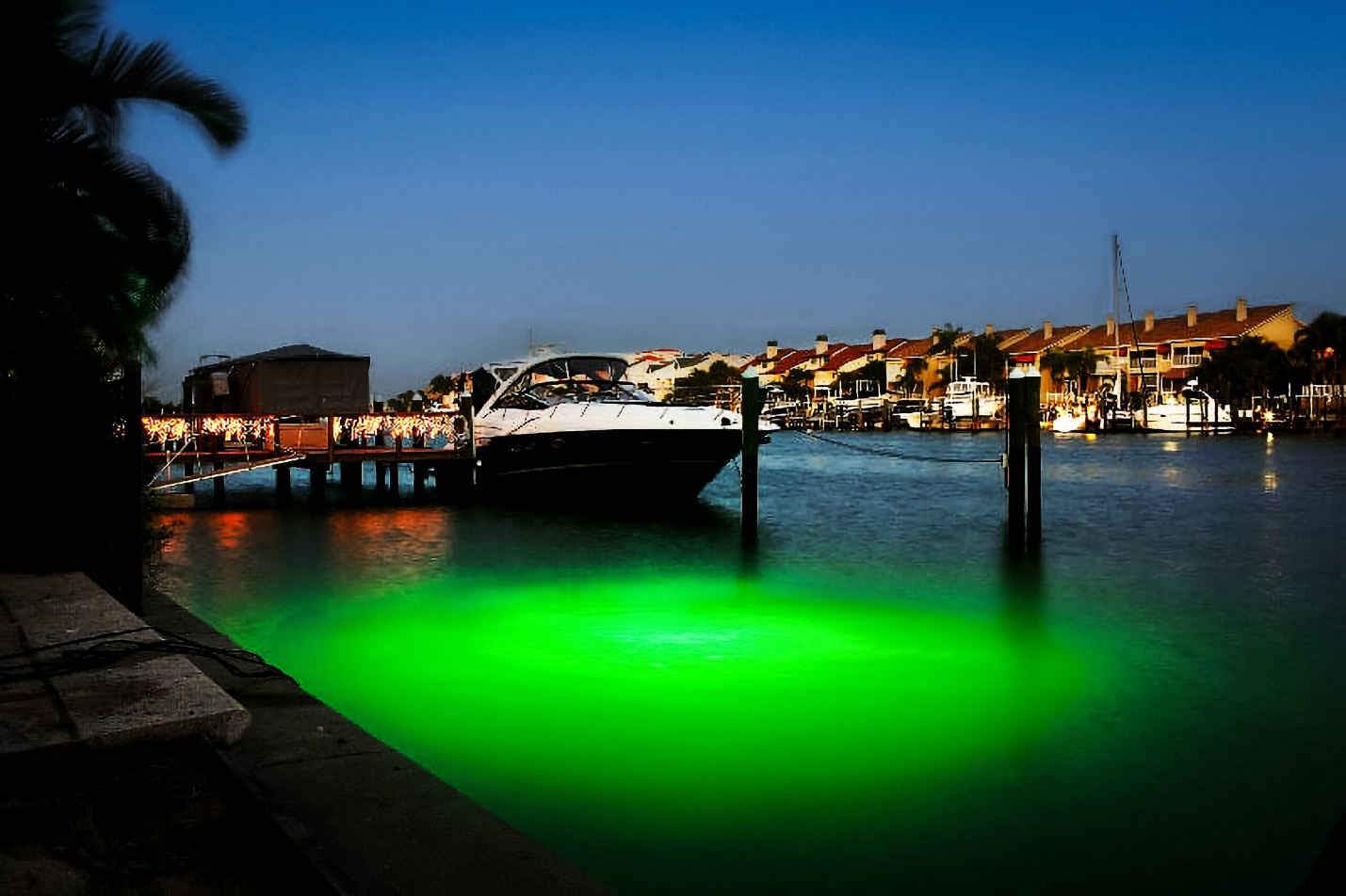 A ship parked at the dock with a green light.