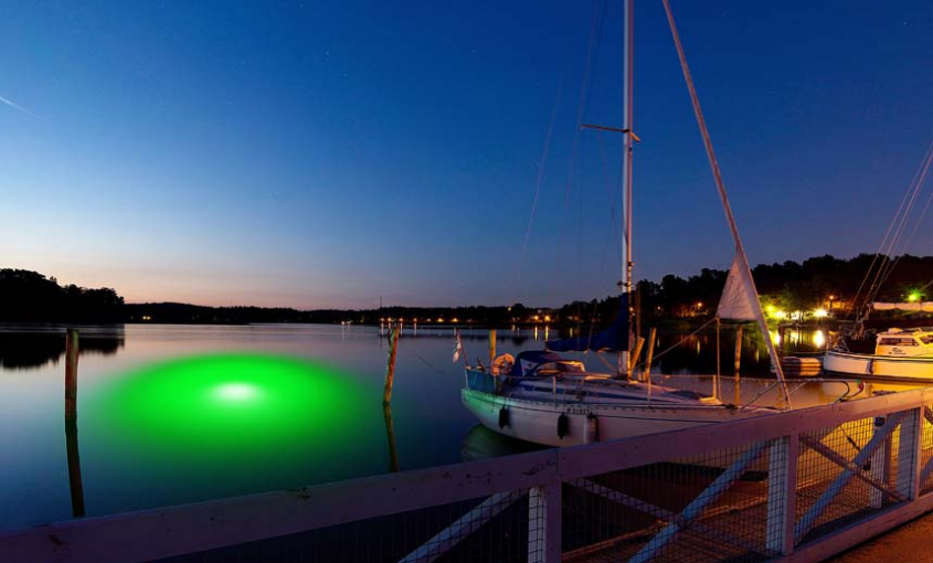 A green-colored LED light underwater.