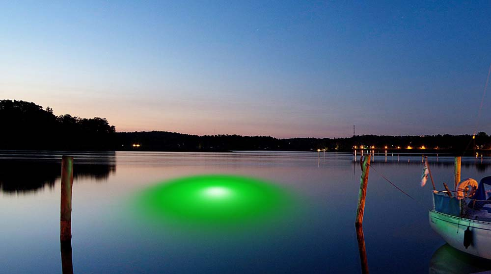 A green-colored LED light underwater.