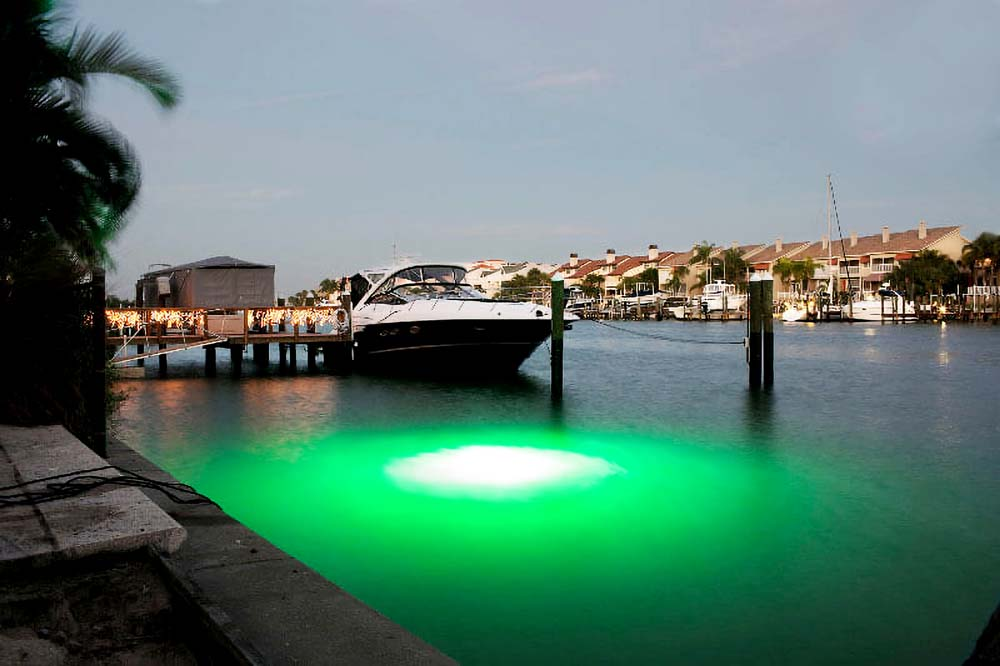 A boat parked next to an underwater lighting.