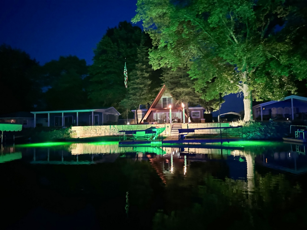 A large water front property with lights. 