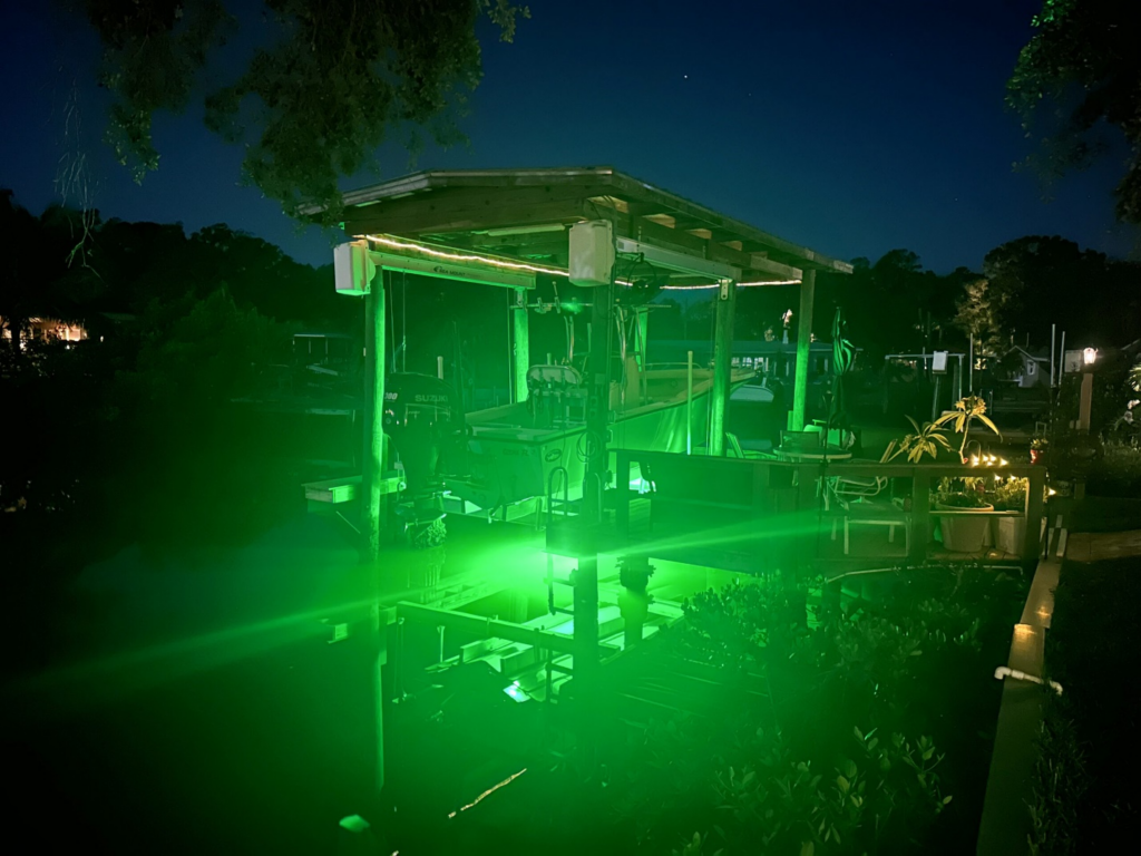 A green LED underwater light near a property.