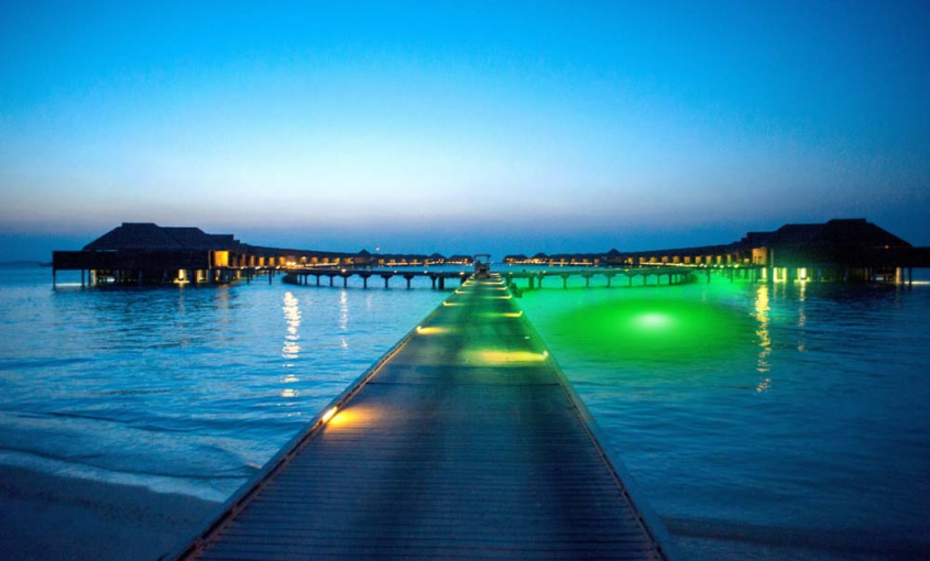 An underwater LED light illuminating the water near a dock