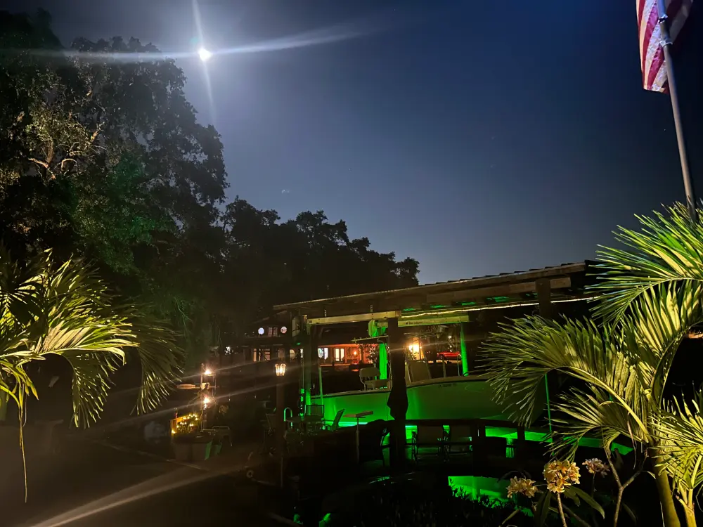A large beach front property with underwater green lights. 