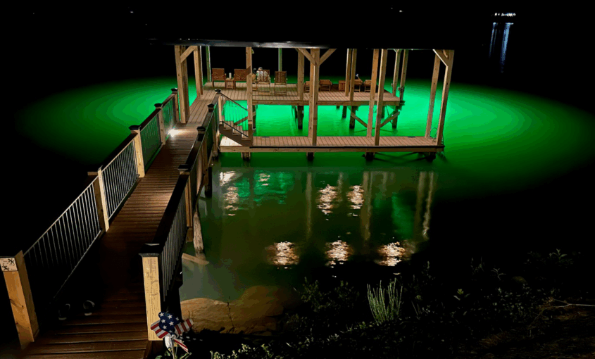 A dock illuminated by underwater green light