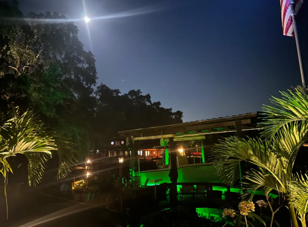 A large waterfront property with green underwater LED Lights.