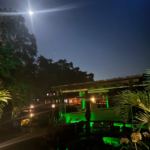 A large waterfront property with green underwater LED Lights.