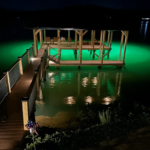 A large space with a waterfront property and underwater LED lights.