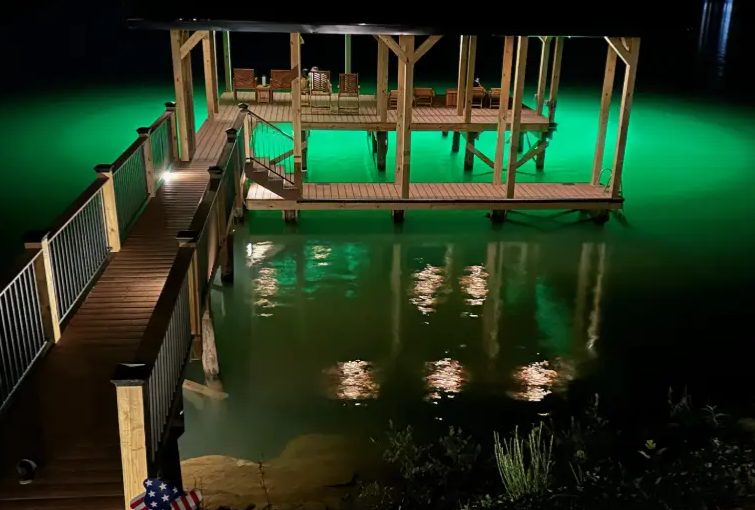 A large space with a waterfront property and underwater LED lights.