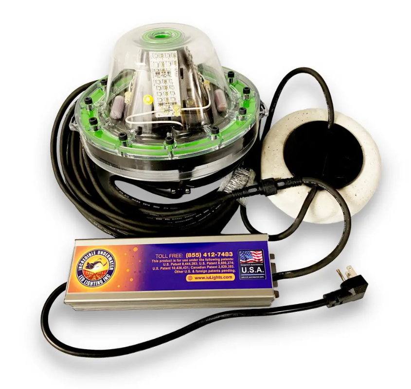 A large underwater LED Light with wires and a battery attached. 