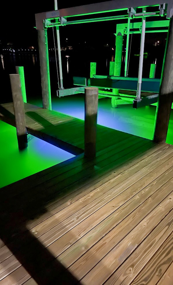 Wooden area with green colored underwater LED lights.