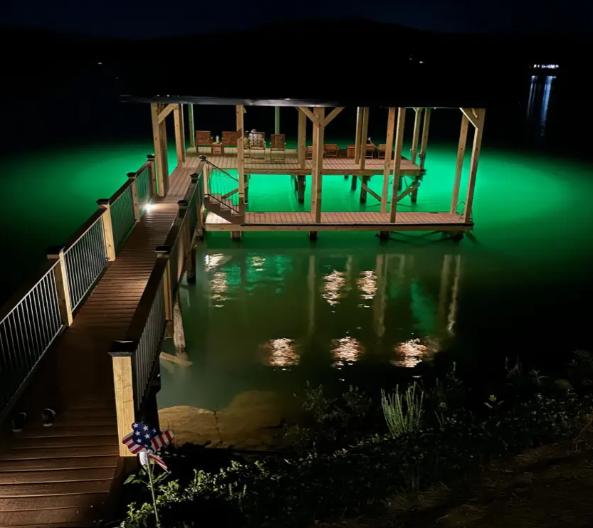 A large body of water with green underwater LED lights.