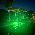 A large space with underwater green lights.